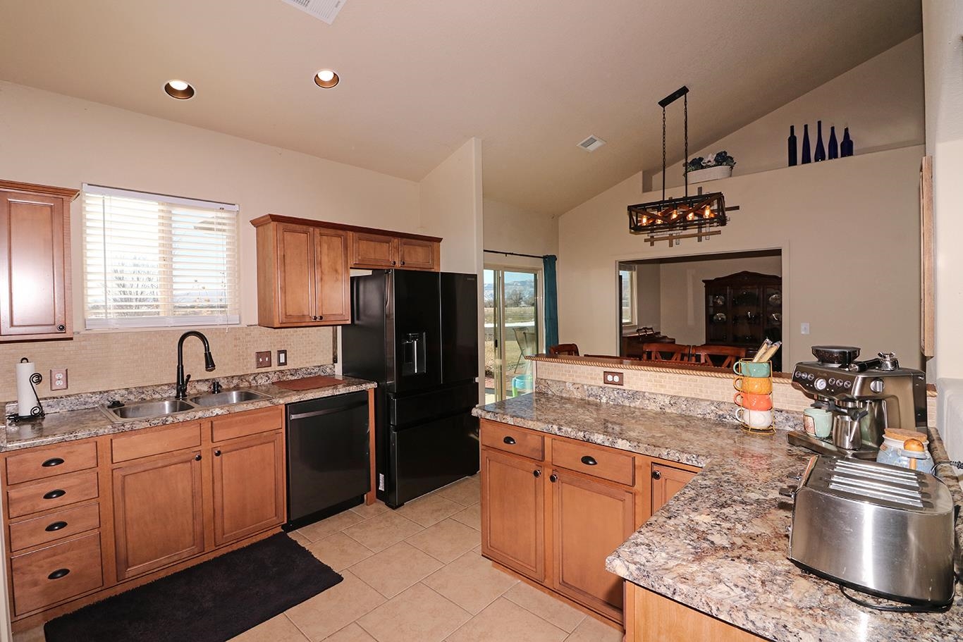 2011 Roma Avenue Fruita, CO 81521 - Photo 8 of 31 a kitchen with stainless steel appliances granite countertop a sink stove and refrigerator
