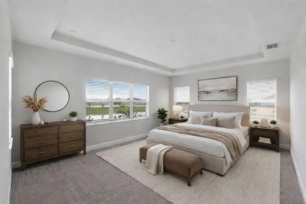a bedroom with a large bed and wooden floor