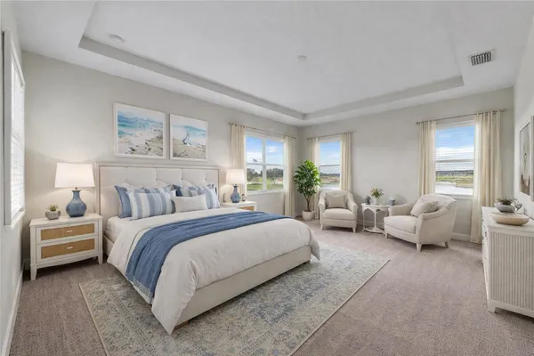 a spacious bedroom with a bed and a couch