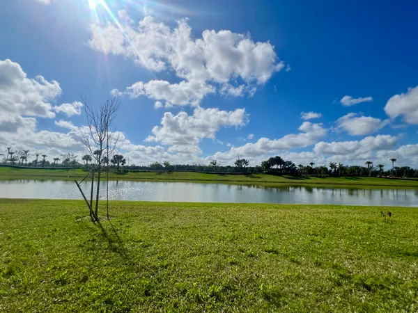 a view of a lake with houses in the back