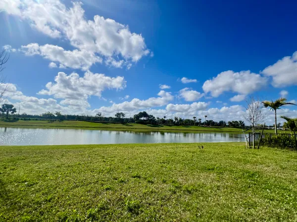 a view of a lake with houses in the background