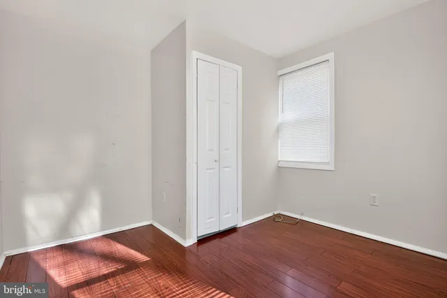 a view of a room with wooden floor and white walls