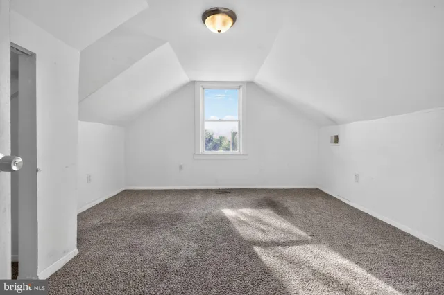 an empty room with windows and mirror