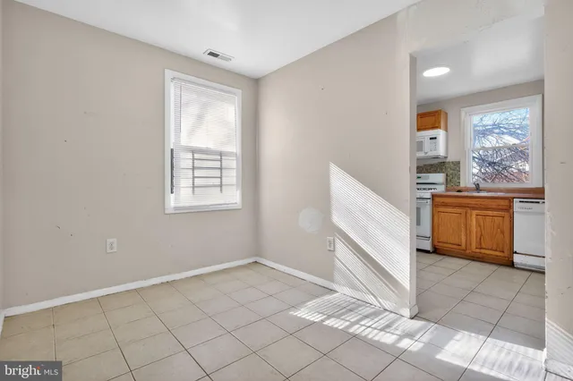 a view of a kitchen with wooden cabinets and floor to ceiling window