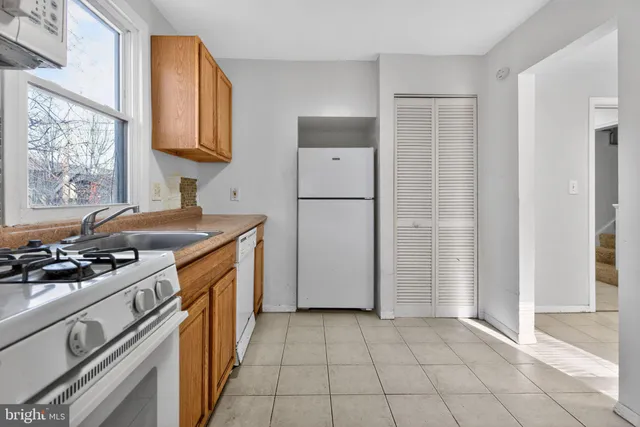 a kitchen with a stove a refrigerator and a sink
