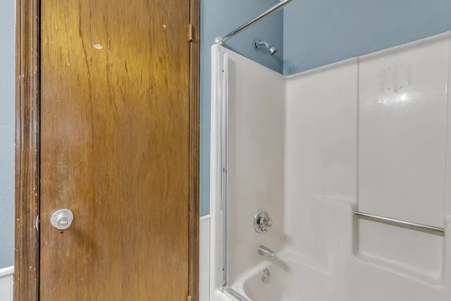 a bathroom with a bathtub and a shower