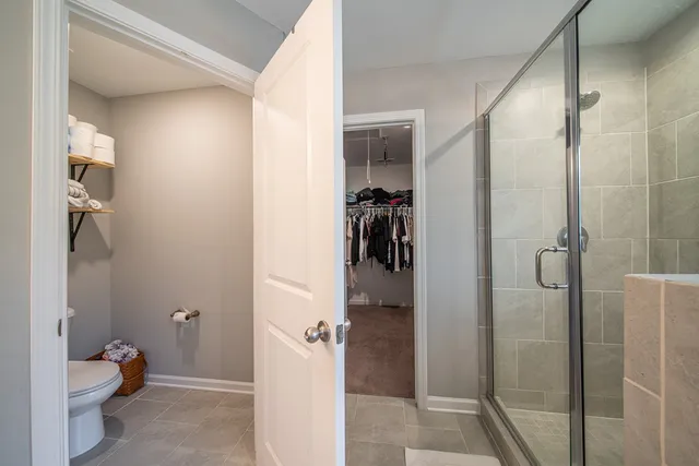 a bathroom with a toilet and a shower