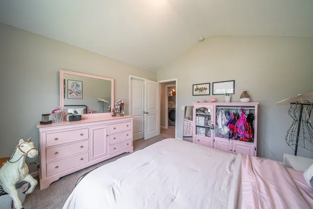 a bedroom with bed and painting on the wall