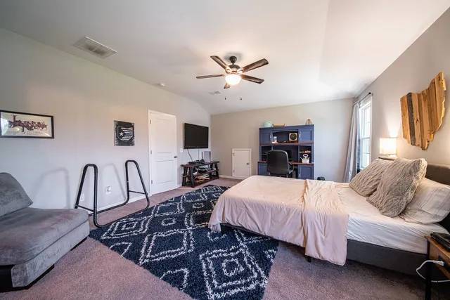 a bedroom with a bed and a couch