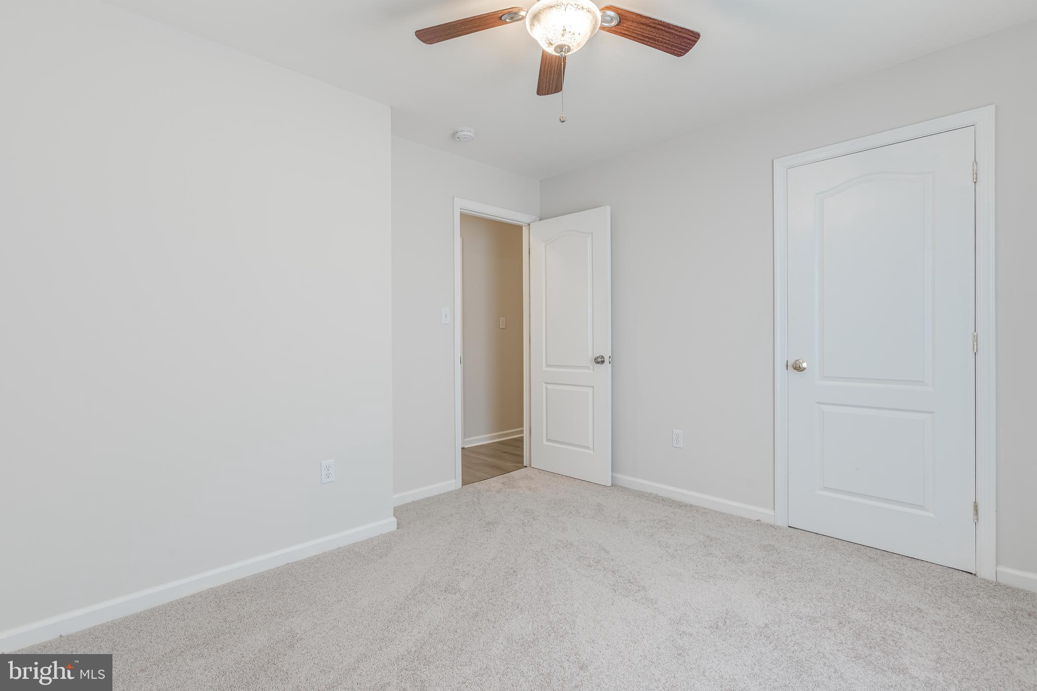 25308 Military Road Cascade, MD 21719 - Photo 28 of 43 an empty room with a chandelier fan