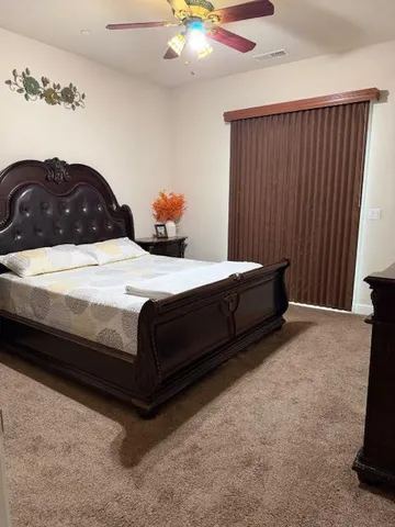a bedroom with a bed and a cabinet