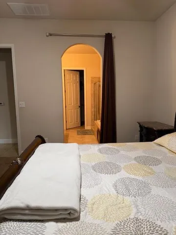 a bedroom with a bed and a mirror