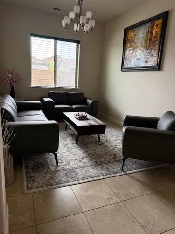 a living room with furniture and a large window