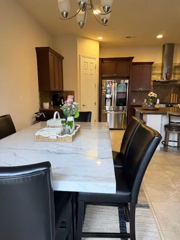 a bedroom with a bed window and a chandelier