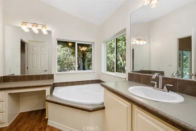 a bathroom with a granite countertop sink and a large mirror