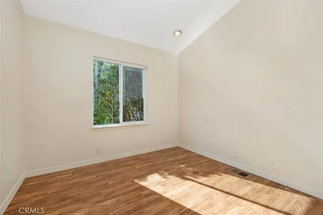 a view of a room with wooden floor and natural light