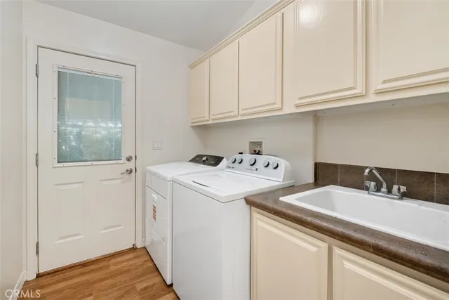 a utility room with sink dryer and washer