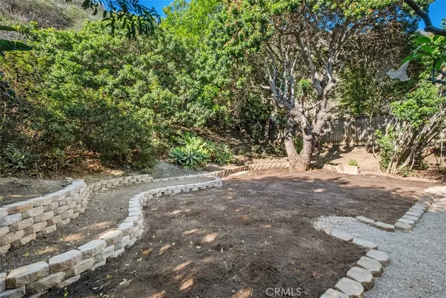 a view of dirt yard with a trees