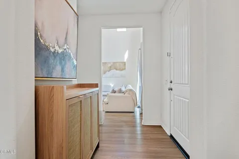a room with a walk in closet and wooden floor