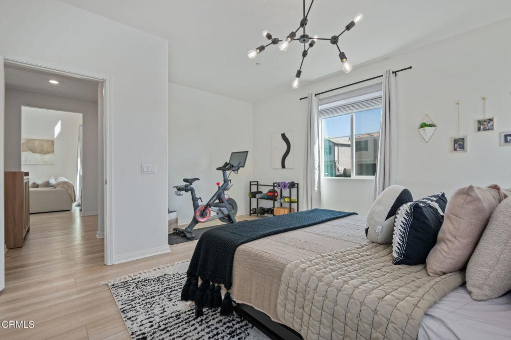 1991 Pomegranate Street Santa Paula, CA 93060 - Photo 14 of 46 a bedroom with bed and a chandelier