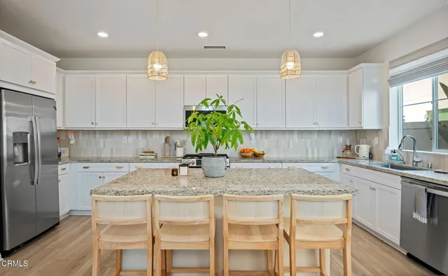 a kitchen with refrigerator a sink and cabinets