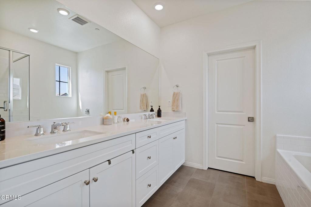 1991 Pomegranate Street Santa Paula, CA 93060 - Photo 29 of 46 a bathroom with a double vanity sink and mirror