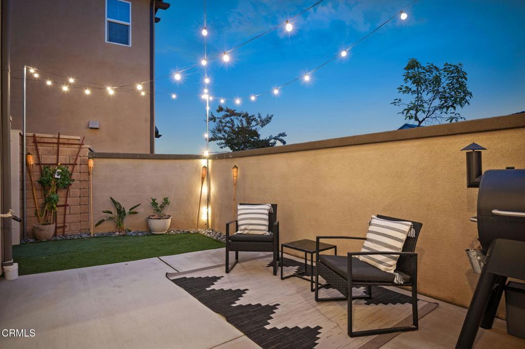 1991 Pomegranate Street Santa Paula, CA 93060 - Photo 3 of 46 a view of a patio with table and chairs with potted plants