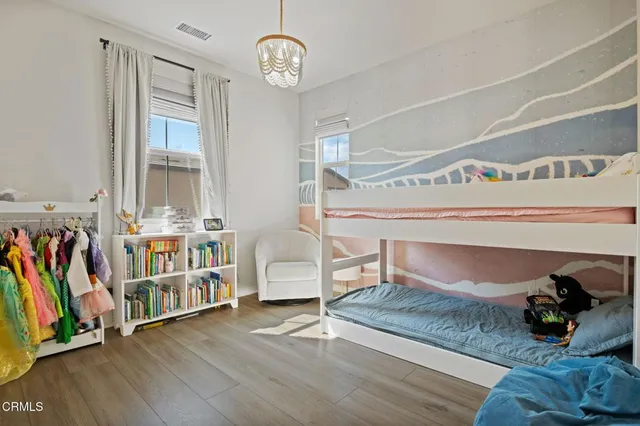 a view of a room with wooden floor and lots of stuff