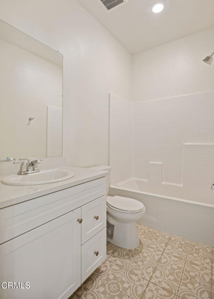 1991 Pomegranate Street Santa Paula, CA 93060 - Photo 33 of 46 a bathroom with a granite countertop toilet a sink and a bathtub