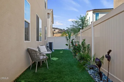 a view of a backyard with sitting area