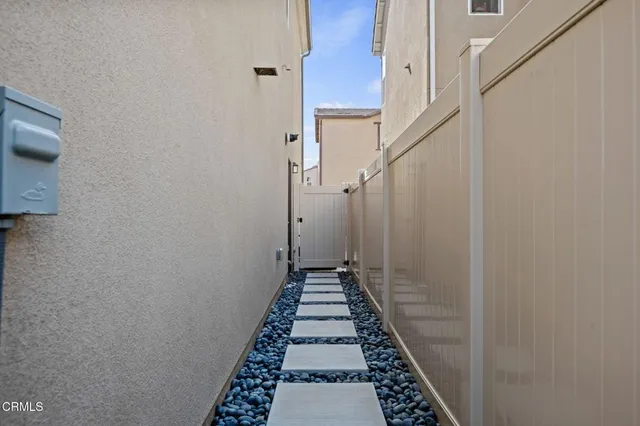 a view of a hallway with a white walls and stairs