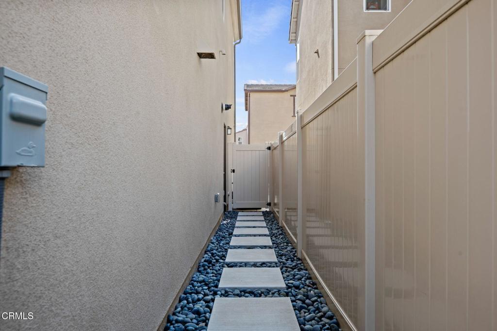1991 Pomegranate Street Santa Paula, CA 93060 - Photo 37 of 46 a view of a hallway with a white walls and stairs