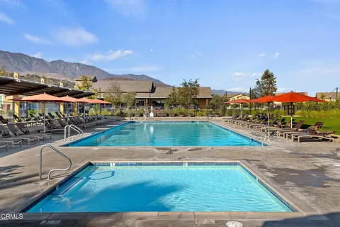a view of a swimming pool with mountains in the background