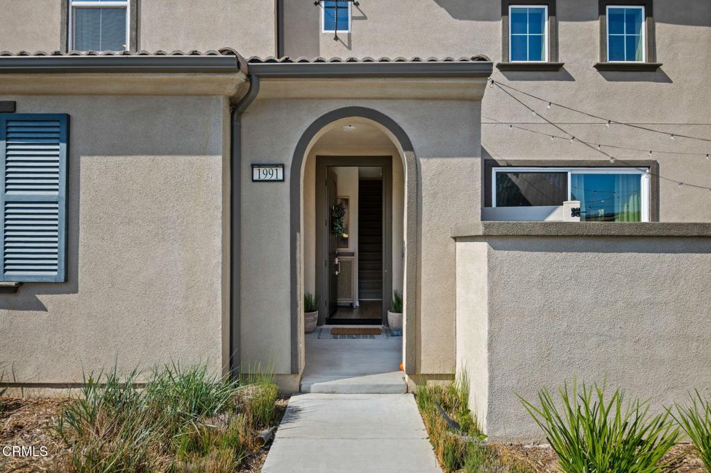 1991 Pomegranate Street Santa Paula, CA 93060 - Photo 8 of 46 a view of a brick house with potted plants