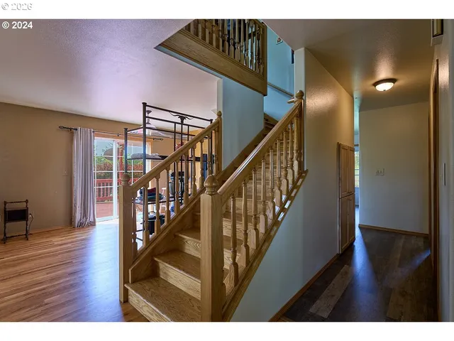 a view of staircase with railing and white walls