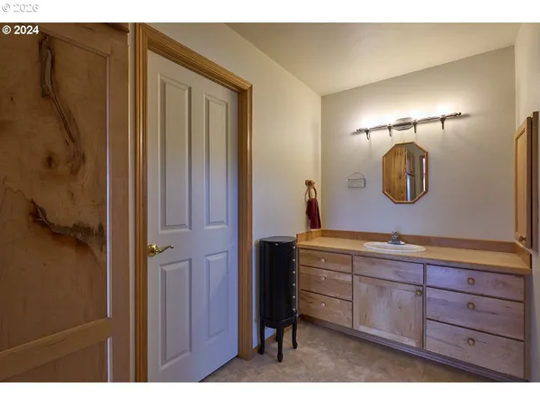 a bathroom with a granite countertop sink a mirror and shower