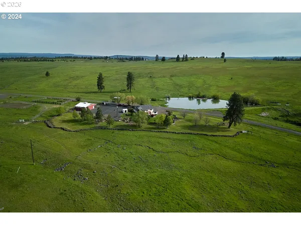 a aerial view of a house with a yard and lake view