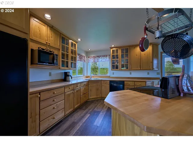 a kitchen that has a microwave a stove and a table