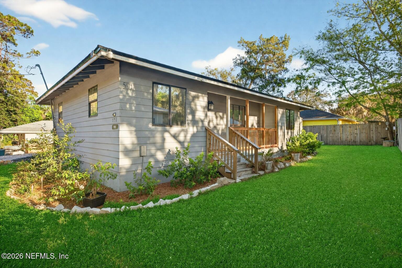 a front view of house with yard and green space
