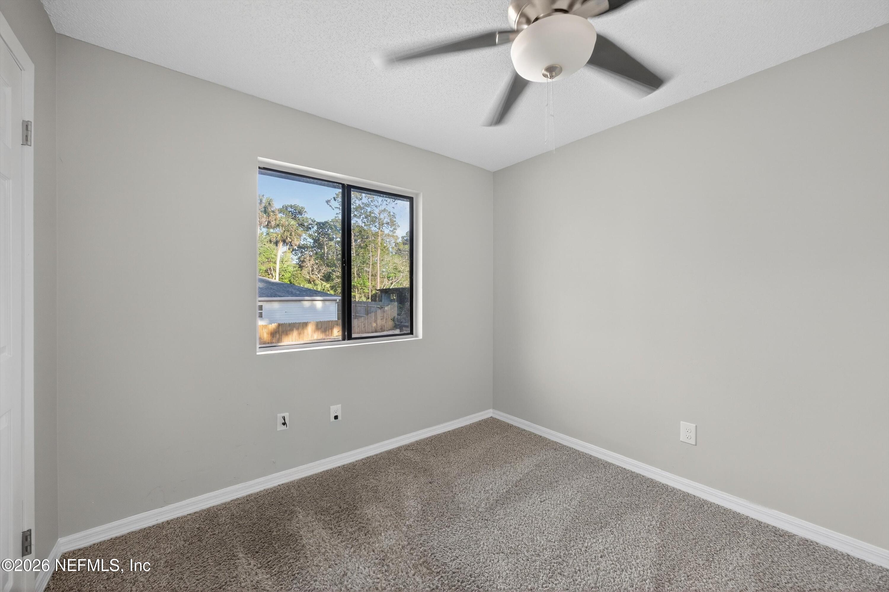 591 Julia Street St. Augustine, FL 32084 - Photo 16 of 25 an empty room with a window and a fan