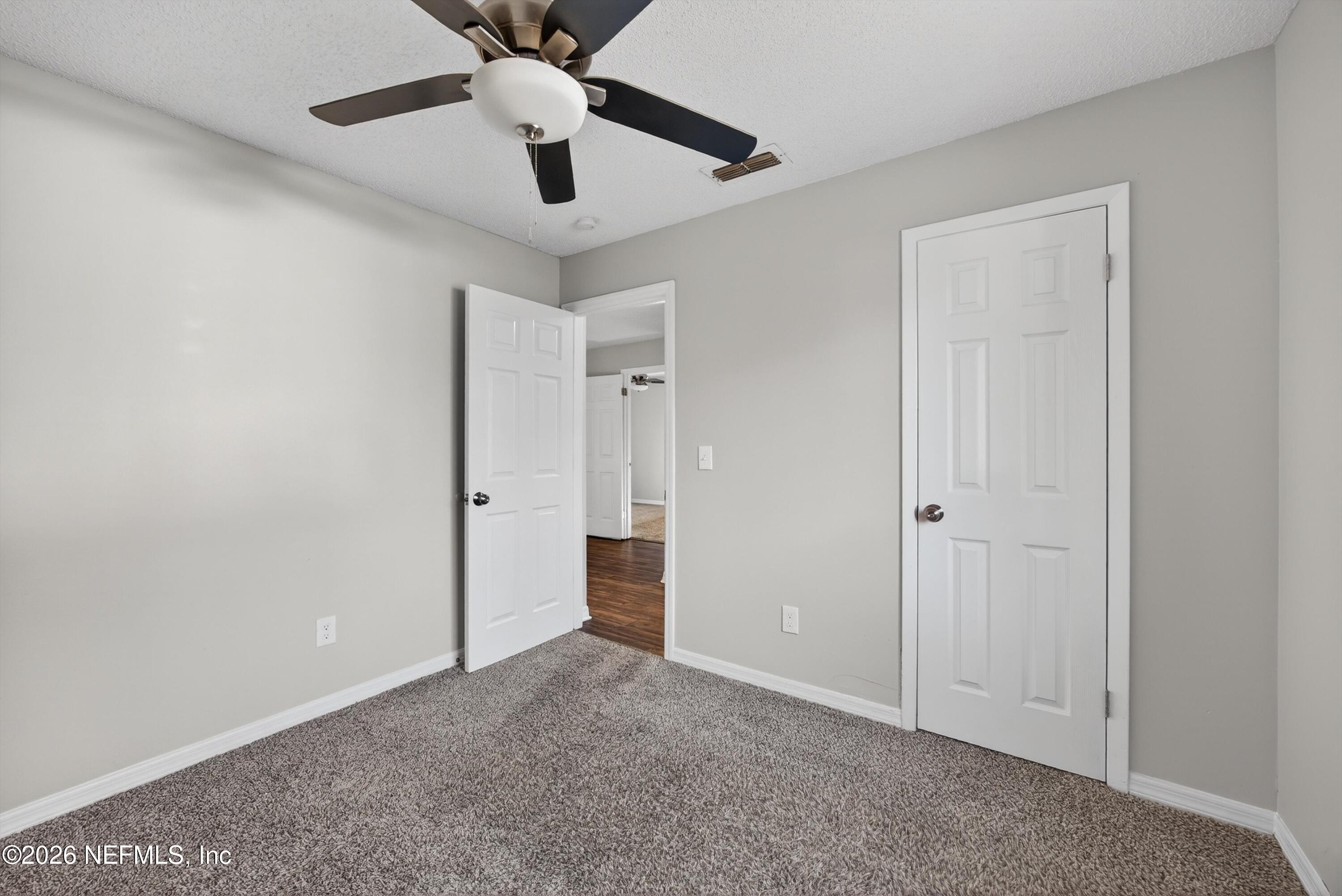 591 Julia Street St. Augustine, FL 32084 - Photo 17 of 25 a view of an empty room and cabinet with a ceiling fan