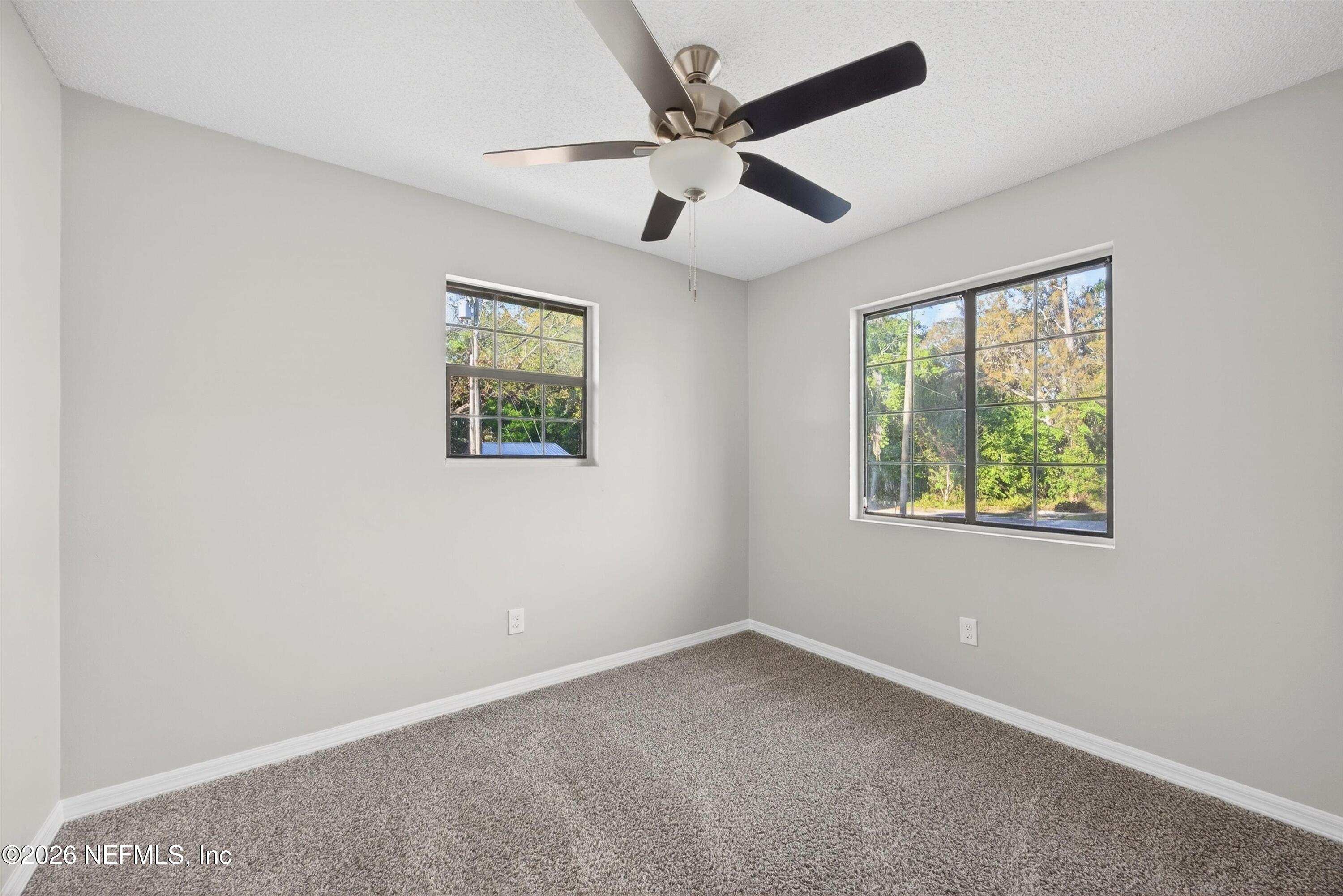 591 Julia Street St. Augustine, FL 32084 - Photo 18 of 25 an empty room with a window and a fan