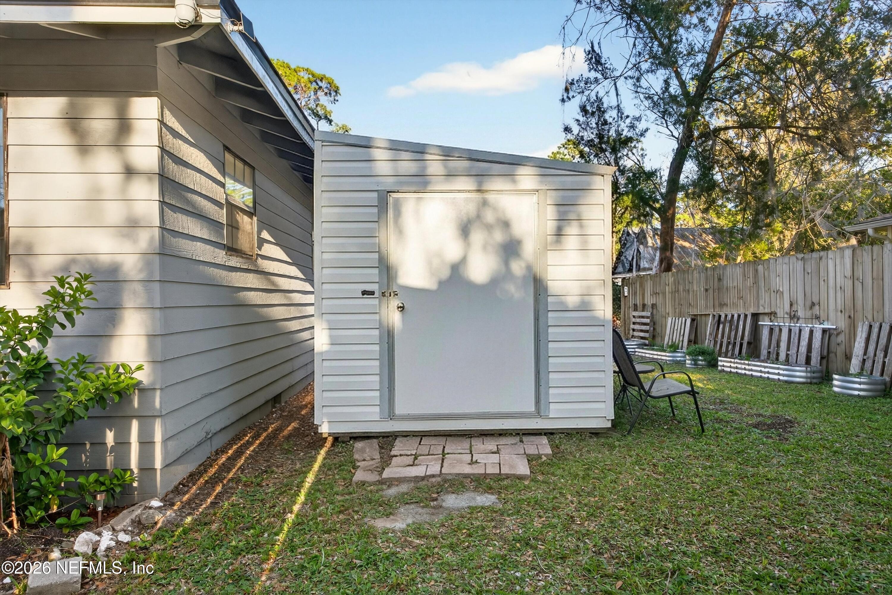 591 Julia Street St. Augustine, FL 32084 - Photo 20 of 25 a view of a back yard of the house with a bench