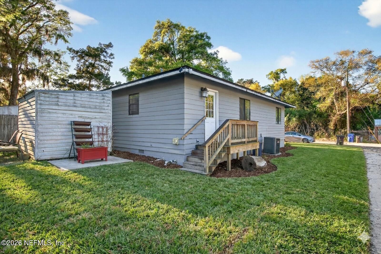 591 Julia Street St. Augustine, FL 32084 - Photo 23 of 25 a front view of a house with a yard and trees
