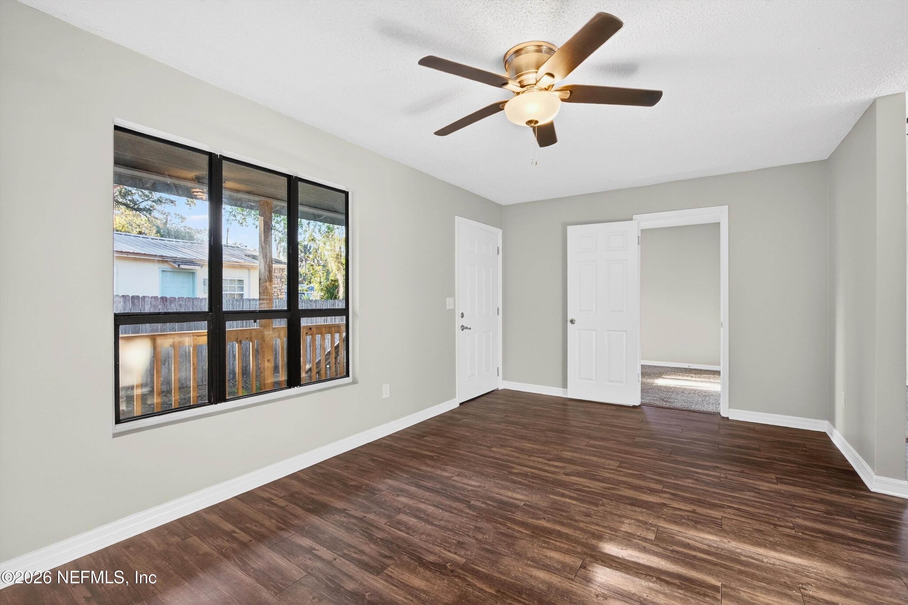 591 Julia Street St. Augustine, FL 32084 - Photo 4 of 25 a view of empty room with wooden floor and fan