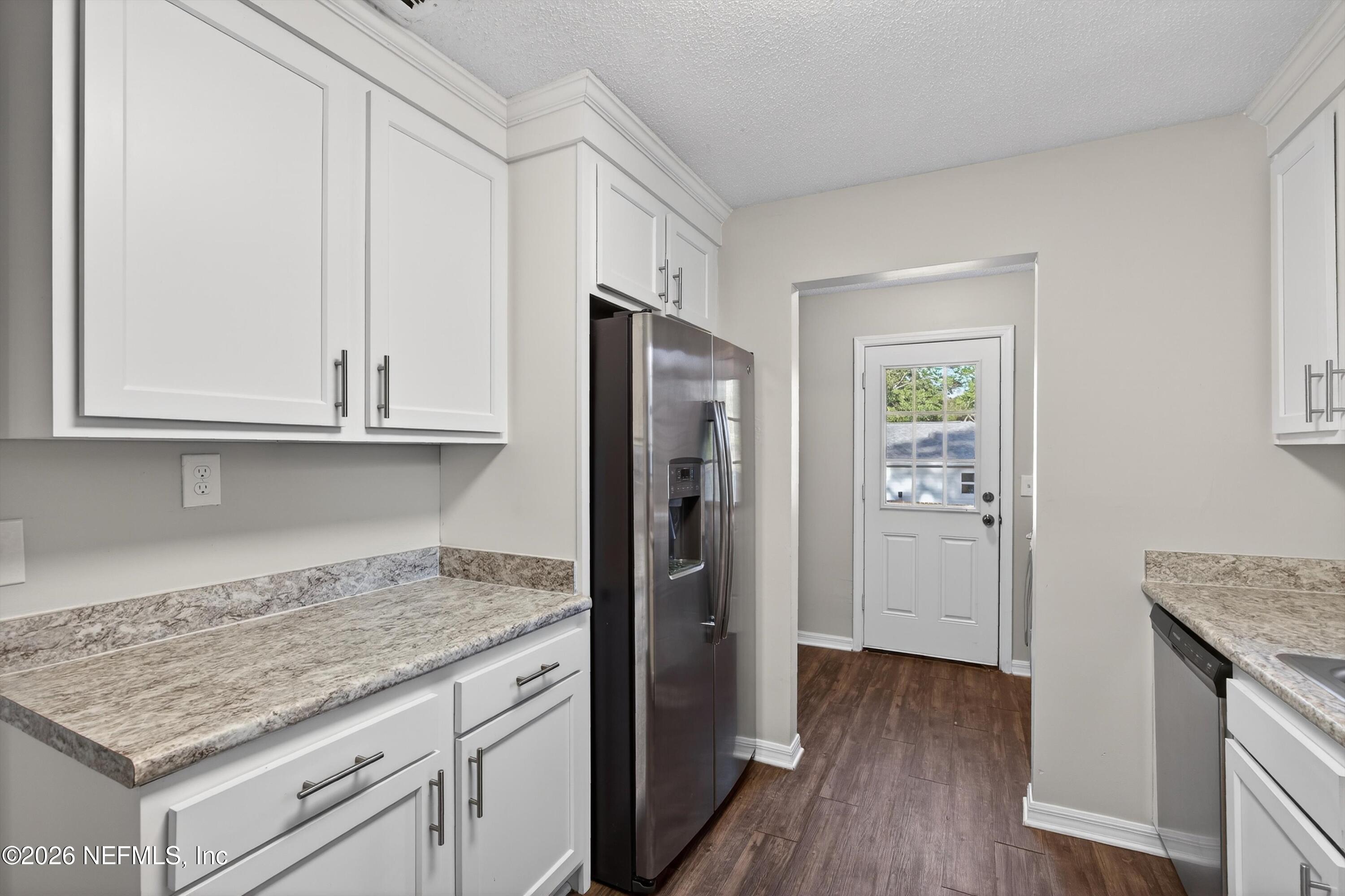 591 Julia Street St. Augustine, FL 32084 - Photo 9 of 25 a kitchen with granite countertop cabinets appliances and a counter space