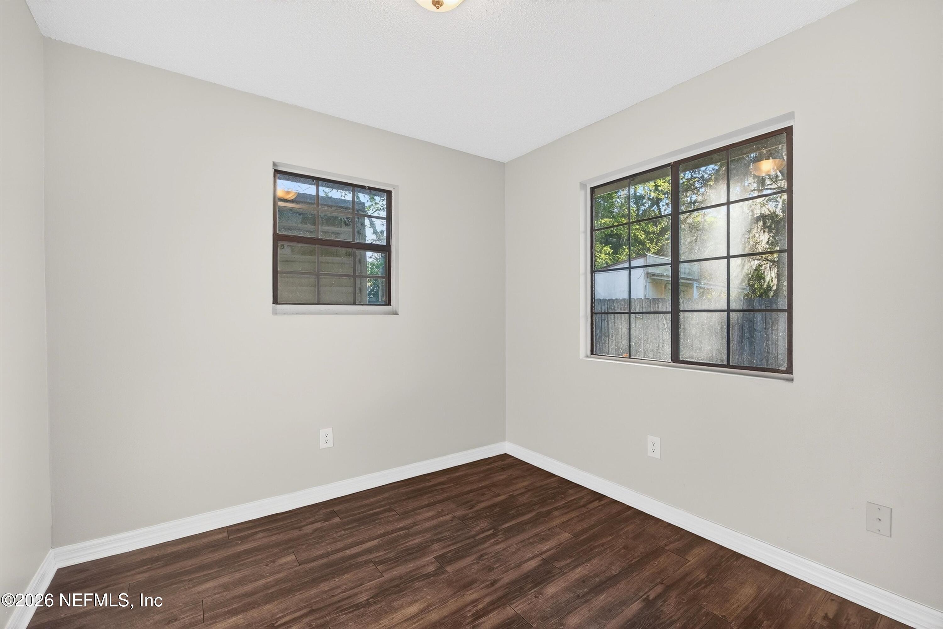 591 Julia Street St. Augustine, FL 32084 - Photo 10 of 25 a view of an empty room with wooden floor and a window