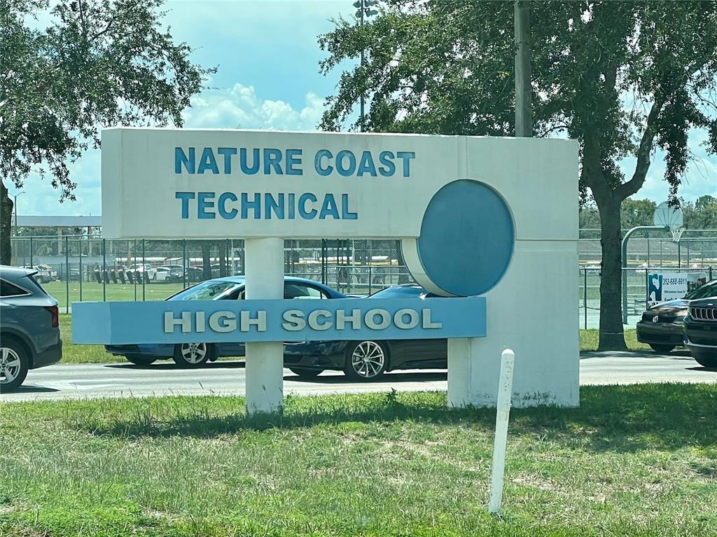 Spring Hill Dr Spring Hill Spring Hill, FL 34604 - Photo 2 of 5 a front view of a house with garden