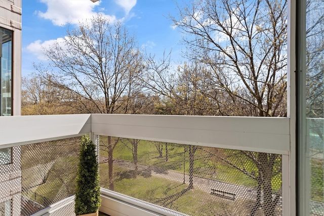 a view of kitchen with stainless steel appliances granite countertop a sink and a wooden floor