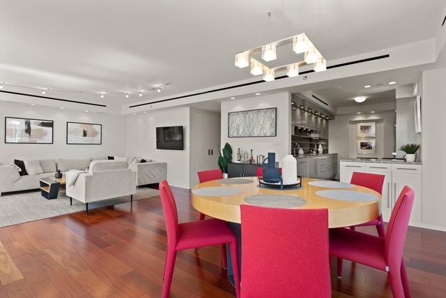 a view of a dining room with furniture and a chandelier